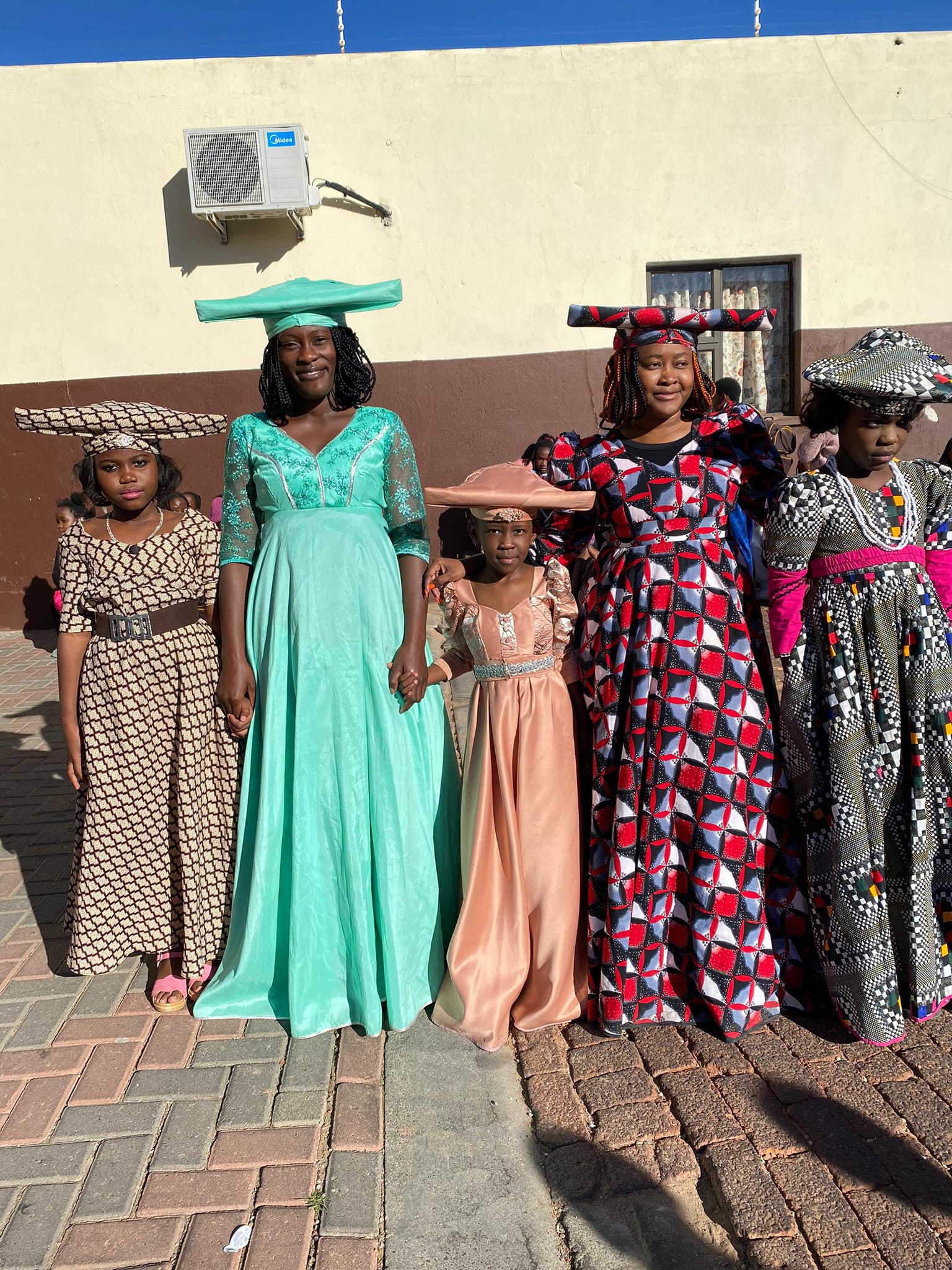 Learners posing together in colourful traditional African clothing